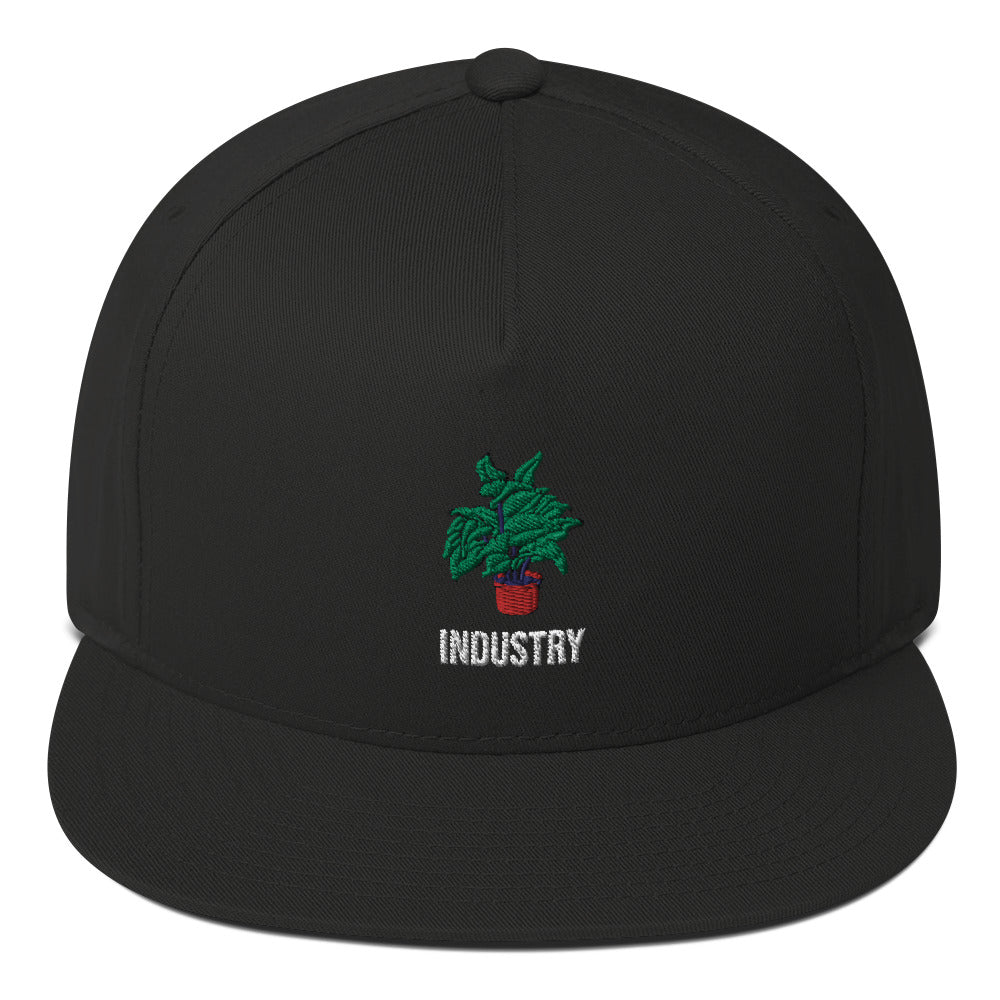A black snapback hat with a green plant logo on the front and the text 'INDUSTRY' below it.