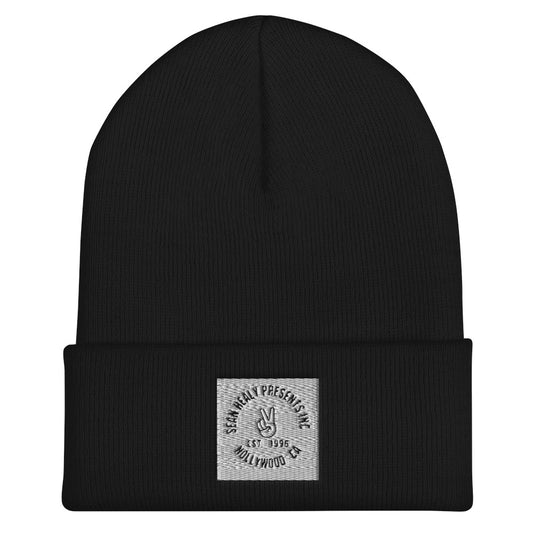 Black beanie with an embroidered white peace logo on the front.