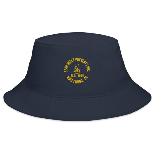 Navy blue cotton twill bucket hat with the SHP Peace logo sewn on the front.