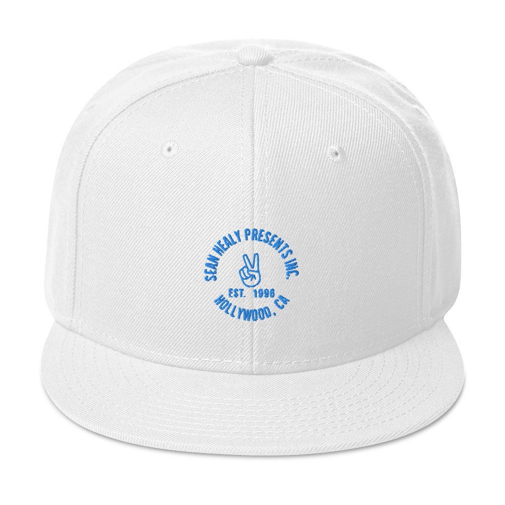 White snapback hat with an embroidered logo on the front panel.